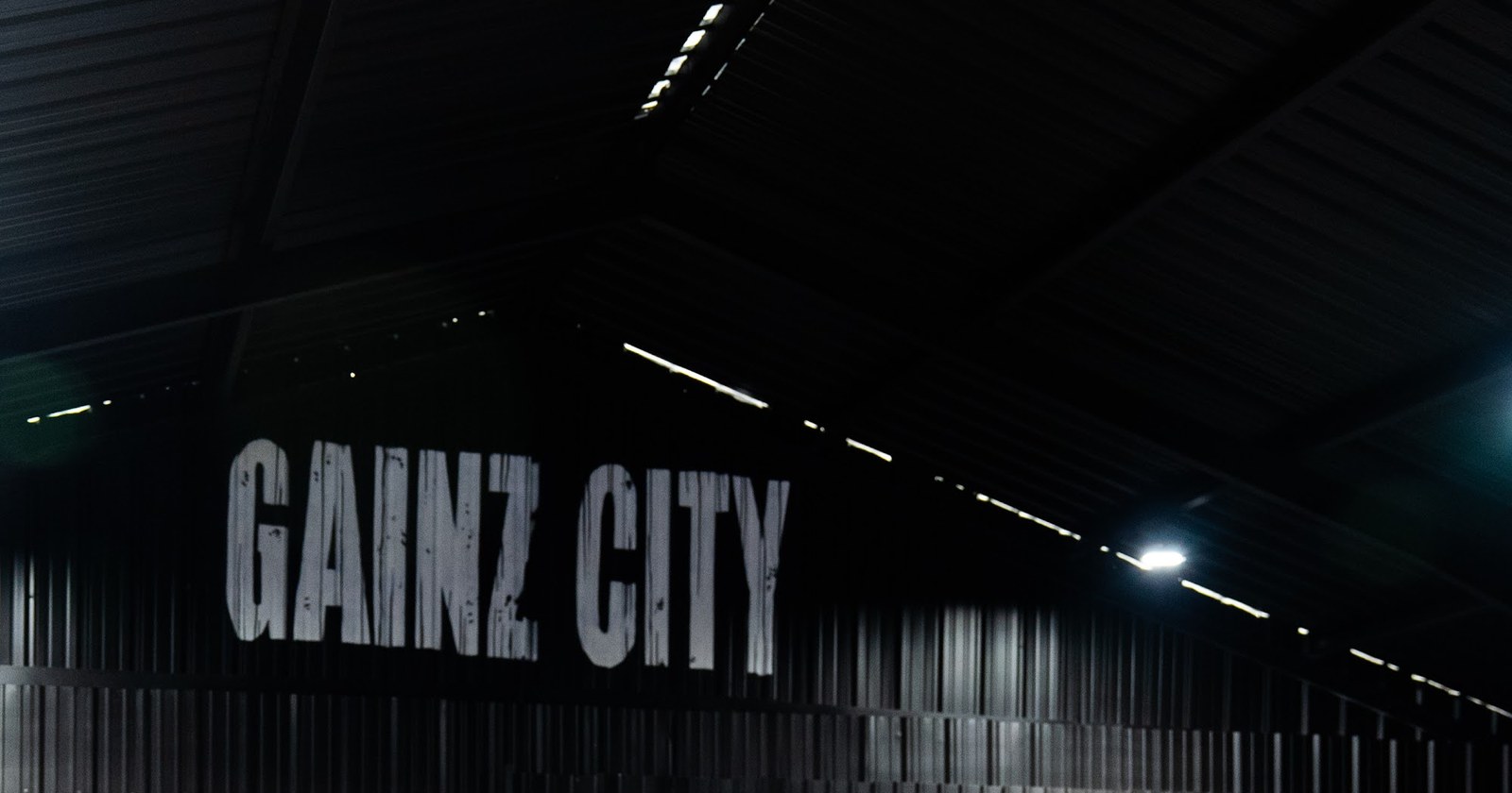 The giant GAINZ CITY letters on the corrugated black warehouse wall